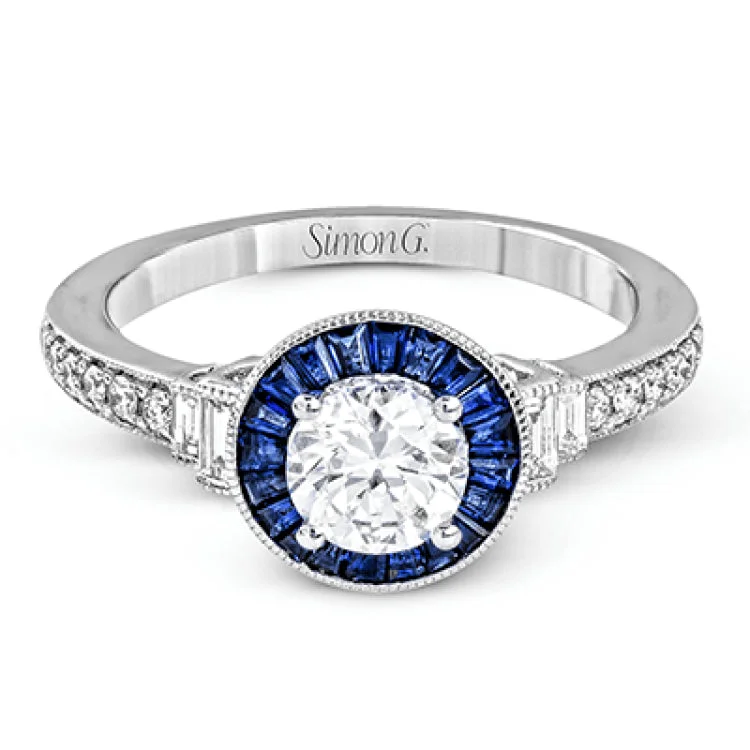 Women’s vintage engagement rings-This 18k white gold engagement ring add something special with .46 ctw of baguette sapphires in a halo around the center stone. A total of .13 ctw of white diamonds and an additional .13 ctw of baguette diamonds finish this remarkable design.