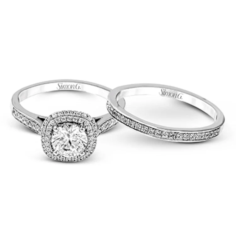 Women’s diamond wedding engagement rings-Showcasing a dazzling halo, this contemporary white gold wedding set is highlighted by .45 ctw of arresting round cut white diamonds.