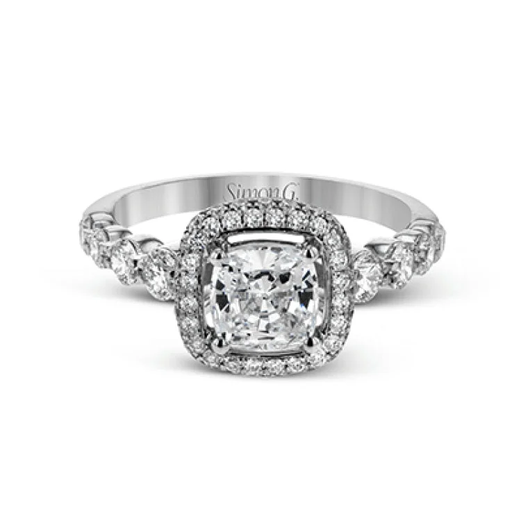 Women’s vintage engagement rings-The delicate design of this classic white gold engagement ring features a sparkling pave halo accented with .86 ctw of shimmering round cut white diamonds.