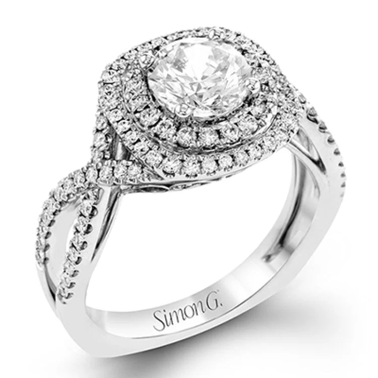 Women’s moissanite engagement rings-This lovely halo engagement ring is crafted in tones of 18k rose and white gold and contains .36 ctw of white diamonds along with .18 ctw of pink diamonds.