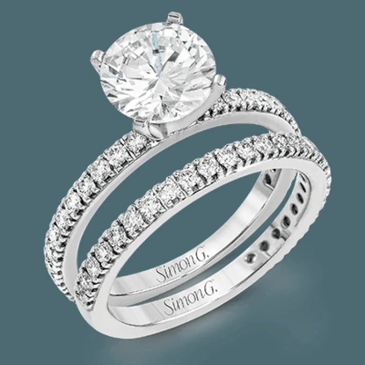 Women’s emerald-cut halo engagement rings-This beautiful 18k white gold wedding set contains a stunning .75 ctw of white round brilliant diamonds.