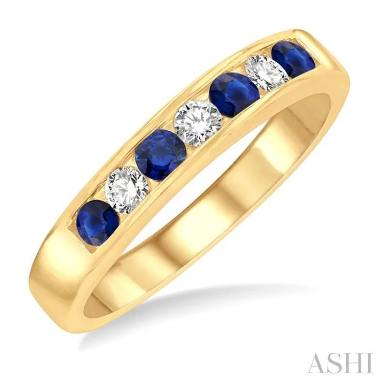 Women’s cushion halo engagement rings-1/5 Ctw Channel Set Round Cut Diamond and 2.5 MM Round Cut Sapphire Band in 14K Yellow Gold