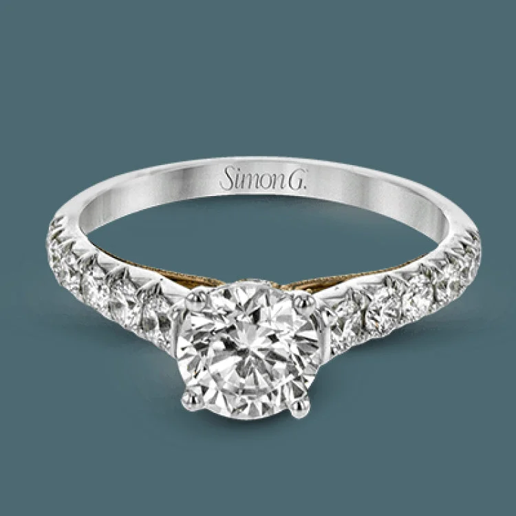 Women’s platinum engagement rings-This beautiful white gold engagement ring is set with .55 ctw of round white diamonds flanking the center stone, as well as a distinctive rose gold accent