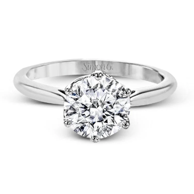 Women’s diamond engagement rings-This 18k white gold engagement ring looks deceptively simple at first, but reveals its intricacy upon closer inspection. Accents of .05 ctw of diamonds decorate the sides of the six-prong center stone setting, creating a stunning effect.