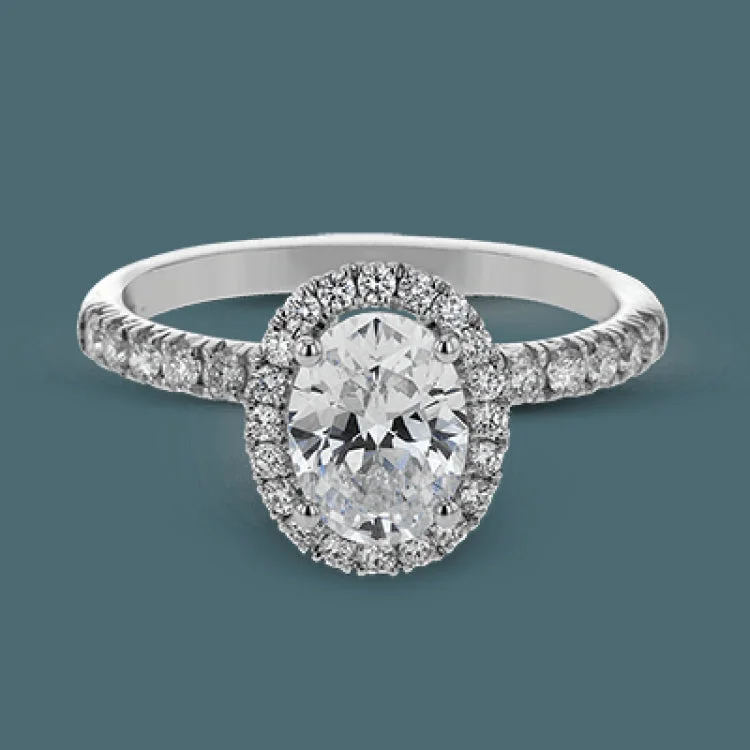 Women’s radiant cut engagement rings-This is a classic halo design wedding set made for an oval center stone contains .72 ctw of white diamonds.