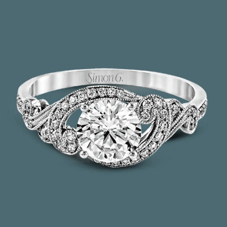 Women’s engagement rings with oval diamonds-This lovely modern white gold engagement ring features a memorable halo and is accentuated by .19 ctw glistening round cut white diamonds.