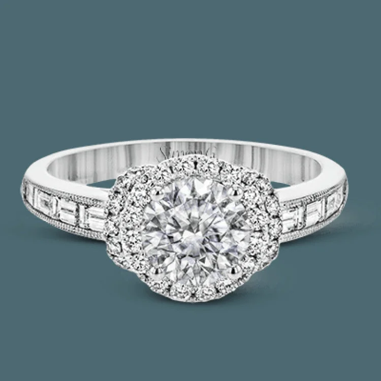 Women’s halo engagement rings-The memorable halo of this white gold engagement ring is accentuated by .33 ctw round cut white diamonds and .47 ctw baguette cut diamonds.