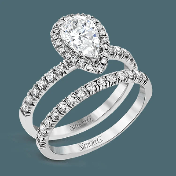 Women’s blue diamond engagement rings-This white gold wedding set is simple yet dazzling with .71 ctw of round white diamonds framing an eye-catching pear shaped centerpiece.