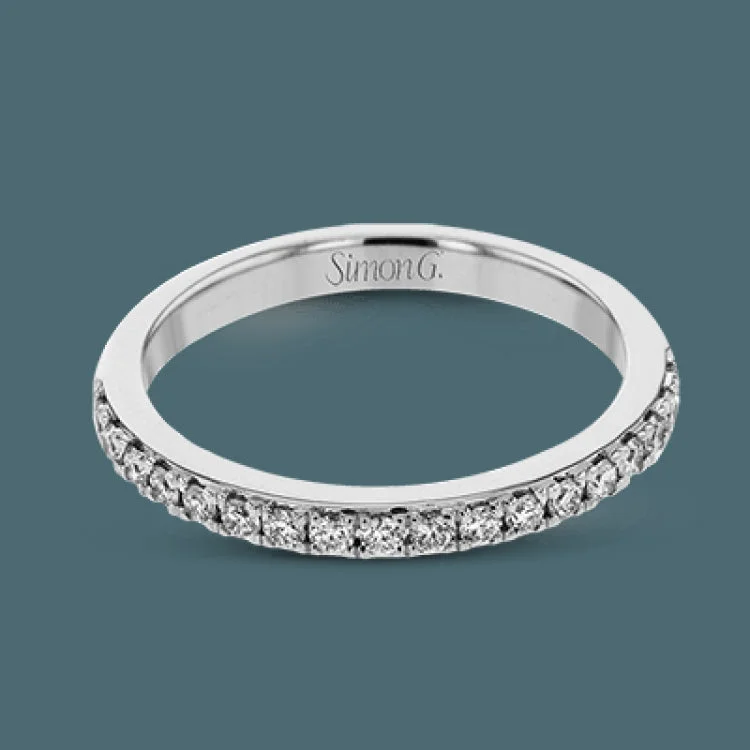 Women’s vintage-style engagement rings-This white gold wedding set frames its centerpiece with .90 ctw of round white diamonds in a whimsical floral-inspired design.