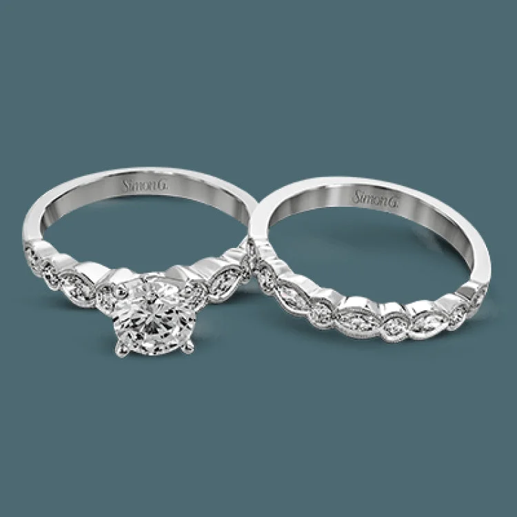 Women’s platinum halo engagement rings-Classically designed, yet featuring a modern flair, this delicate white gold engagement ring and wedding band set are accentuated with .28 ctw round cut white diamonds and .46 ctw marquise cut diamonds.