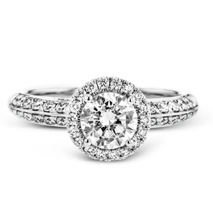 Women’s affordable diamond engagement rings-This delicate, vintage-inspired engagement ring sparkles with .42 ctw of round white diamonds in its halo and side details, all set in beautiful white gold.