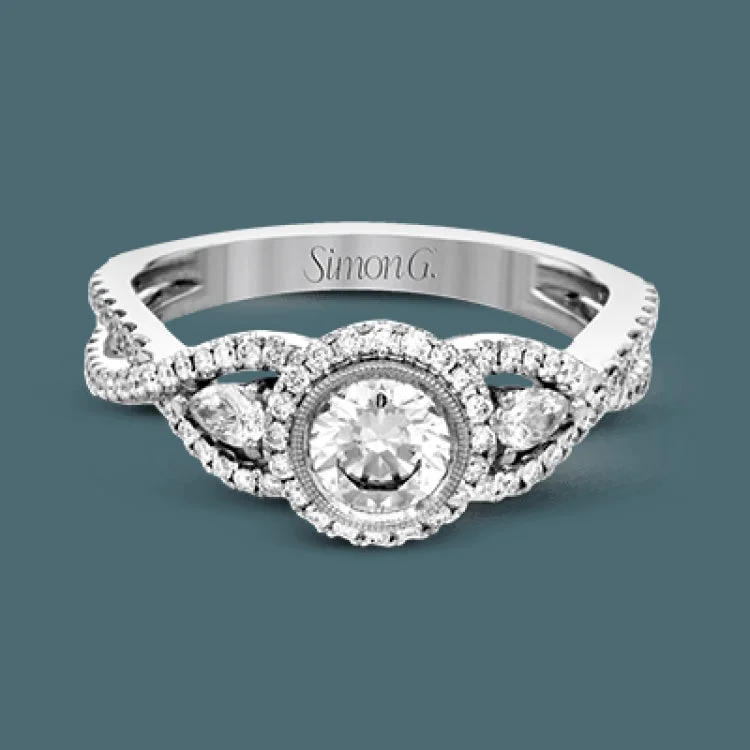 Women’s engagement rings with colored stones-This 18k white gold wedding set has a distinctive design with a milgrain accented bezel center stone setting, .15 ctw pear side stones, and .50 ctw of round brilliant diamonds.