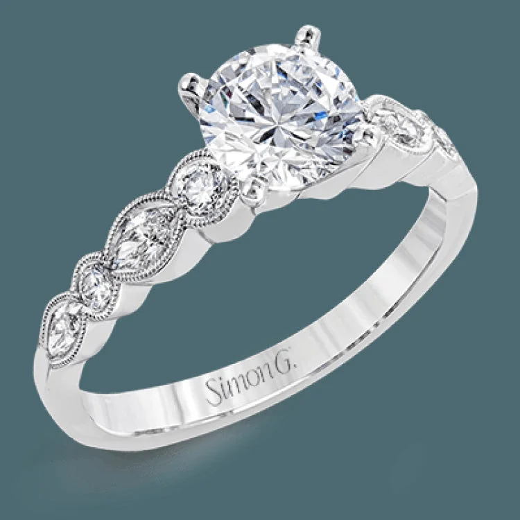 Women’s princess diamond engagement rings-Classically designed, yet featuring a modern flair, this delicate white gold engagement ring and wedding band set are accentuated with .28 ctw round cut white diamonds and .46 ctw marquise cut diamonds.