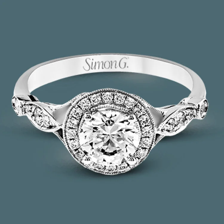 Women’s engagement rings with sapphires-This sparkling white gold vintage inspired engagement ring features an exquisite halo and is set with .25 ctw round cut white diamonds.