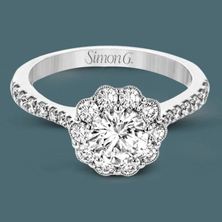 Women’s round solitaire engagement rings-This white gold wedding set frames its centerpiece with .90 ctw of round white diamonds in a whimsical floral-inspired design.