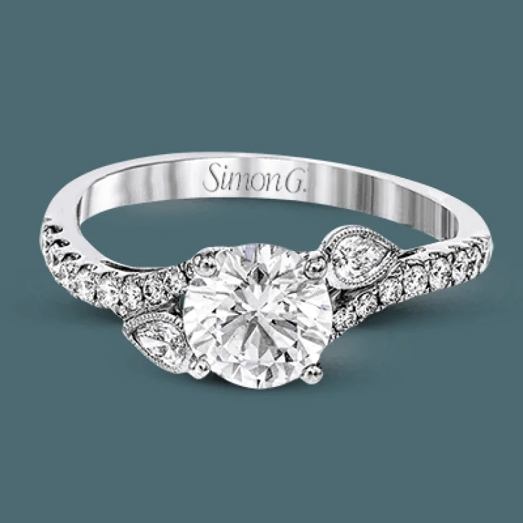 Women’s stackable engagement rings-This lovely 18k white gold engagement ring contains .20 ctw of white round brilliant diamonds, highlighted by .10 pear shaped white diamonds.