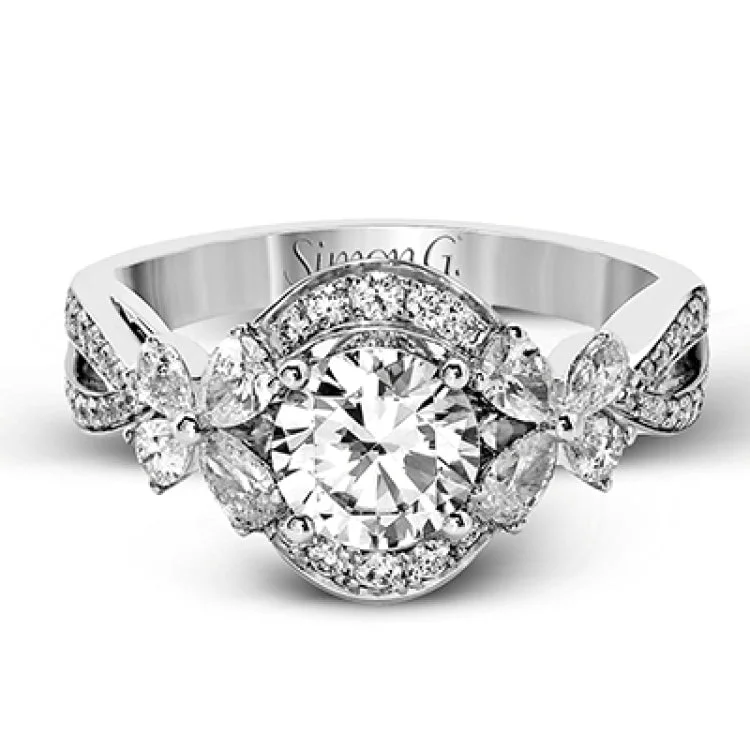 Women’s vintage-inspired engagement rings-Dramatic yet romantic, this exquisite white gold engagement ring features .30 ctw of round cut white diamonds highlighted by .54 ctw of pear shaped diamonds in delicate floral motifs.