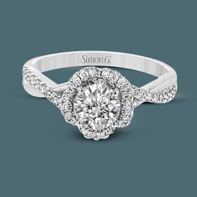 Women’s elegant engagement rings-This delicately glamorous engagement ring glitters with .24 ctw of round white diamonds set into its twisted shank and distinctive rippling halo.