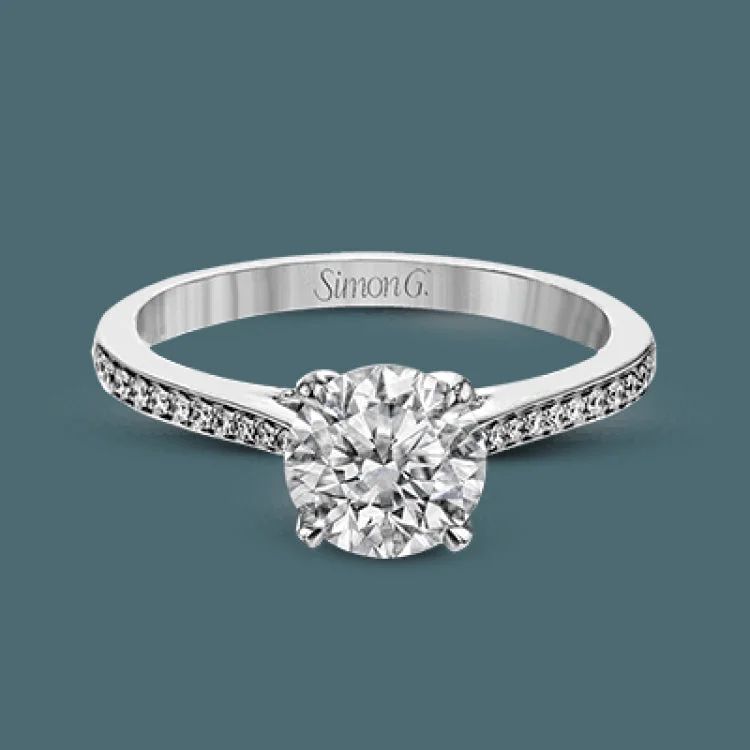 Women’s classic engagement rings-This white gold engagement ring has a clean, minimalist design punctuated with .17 ctw of round white diamonds.