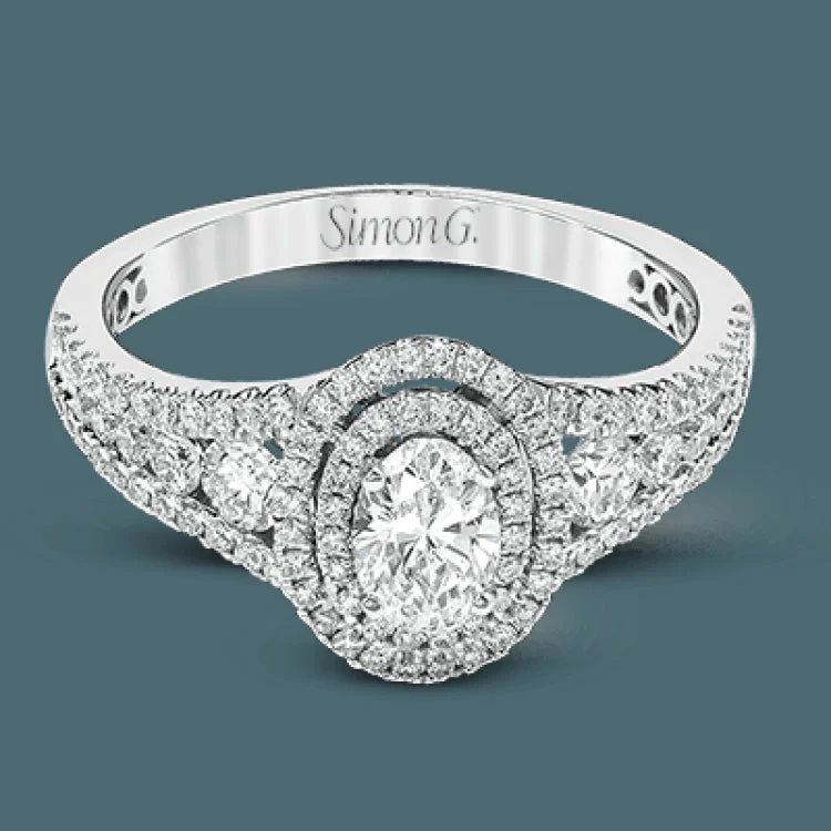 Women’s engraved engagement rings-Featuring an exquisite contemporary design, this white gold engagement ring features an eye-catching oval double halo complemented by .68 ctw of round cut white diamonds.