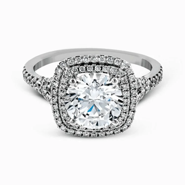 Women’s white diamond engagement rings-This remarkable white gold engagement ring and wedding band set features a contemporary setting with an eye-catching halo highlighted by .67 ctw of round cut white diamonds.